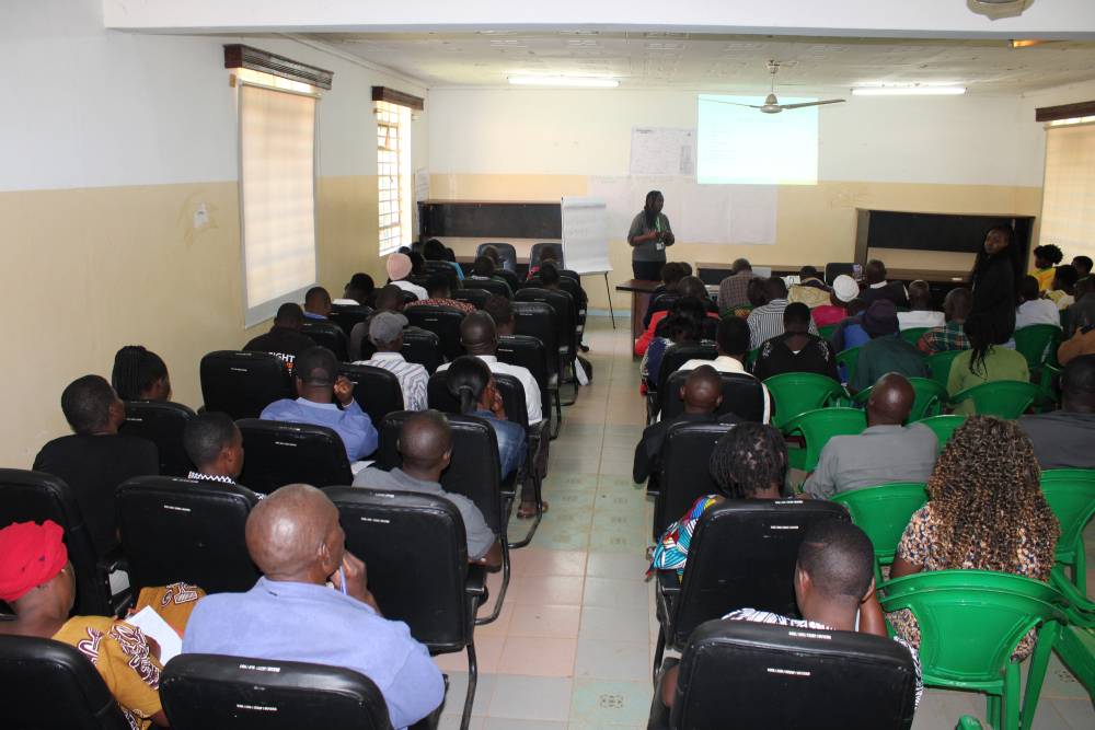 Participants seated in rows in a hall during a focus group discussion