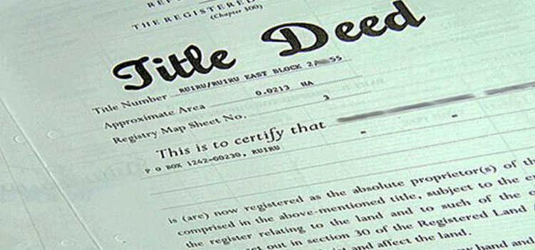 Close-up of a Kenyan title deed issued under the Registered Land Act, its title number partly obscured