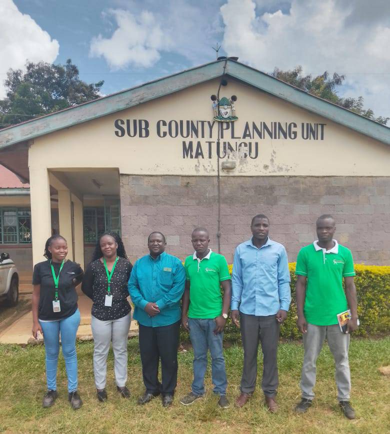 Six socio-economic mappers standing outside the Matungu sub-county planning unit