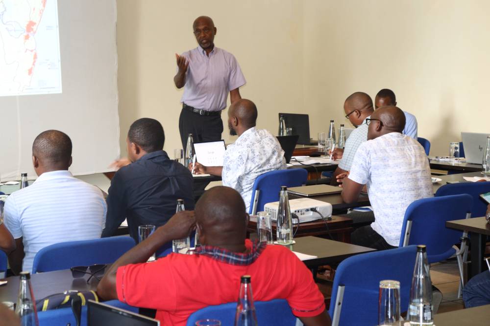 A presenter standing to address seated participants at a stakeholder engagement session