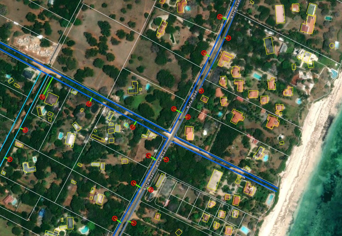 Satellite imagery of a coastal strip either side of Bofa Road, overlaid with white parcel boundaries, yellow building footprints, blue water mains along the roads and red service connection points